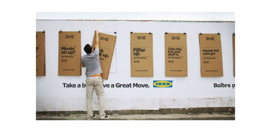 IKEA flat-pack boxes used as recruitment and campaign posters on a wall