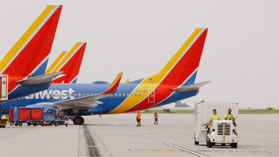 Southwest Airlines aircraft on the tarmac with ground crew employees at work